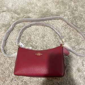 Red medium sized coach purse.